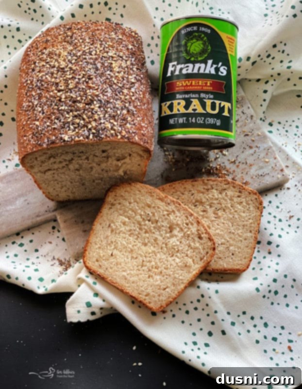 Close-up of a rustic loaf of Everything Sauerkraut Bread with a golden-brown crust.