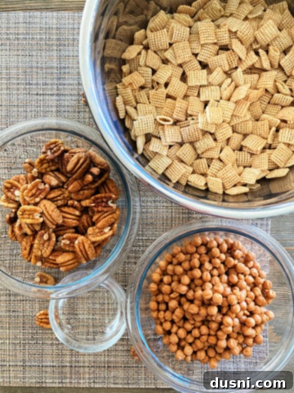 The three essential ingredients for Caramel Pecan Clusters: pecans, Chex Mix cereal, and caramel bits.