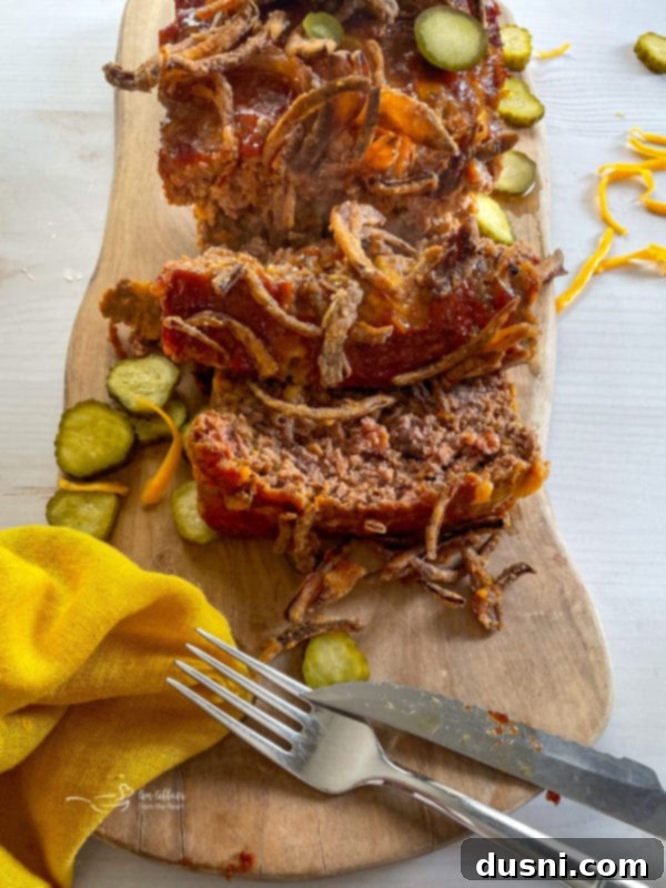 slices of cheesy bacon cheeseburger meatloaf on a rustic wooden board, ready to serve
