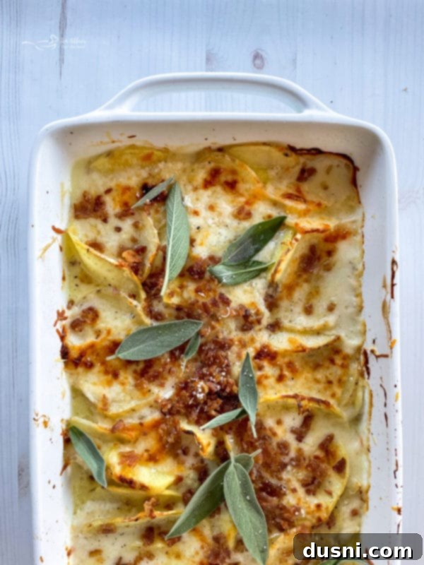 top view of potatoes au gratin in baking dish with bacon and sage leaves