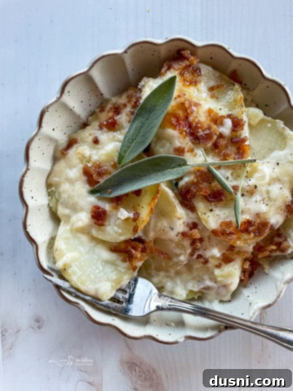 one bowl of potatoes au gratin topped with sage and bacon