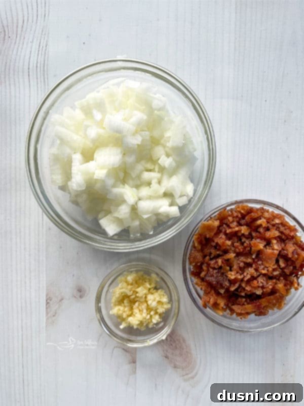 three bowls filled with onions, bacon, and garlic 