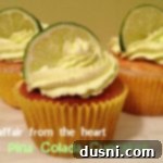 Side view of Pina Colada Cupcakes on a white plate