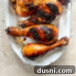 Sticky Sweet Grilled Chicken 14 Sweet and Sticky Grilled Chicken on a serving plate, garnished with green onions and sesame seeds