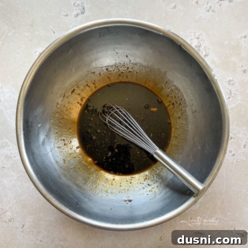 Sticky Sweet Grilled Chicken 6 Step-by-step image of whisking marinade ingredients