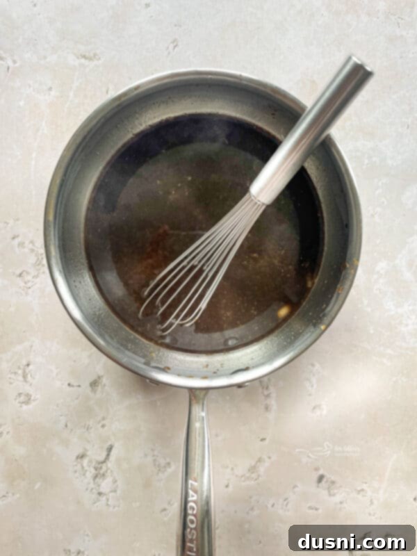 Sticky Sweet Grilled Chicken 9 Marinade simmering in a small saucepan on the stove