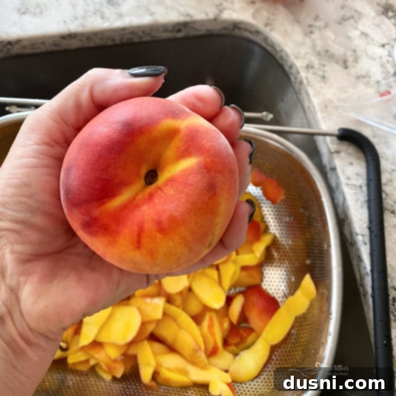 Golden Crumb Spiced Peach Pie 4 Large, fresh peaches on a wooden surface, ready for preparation.