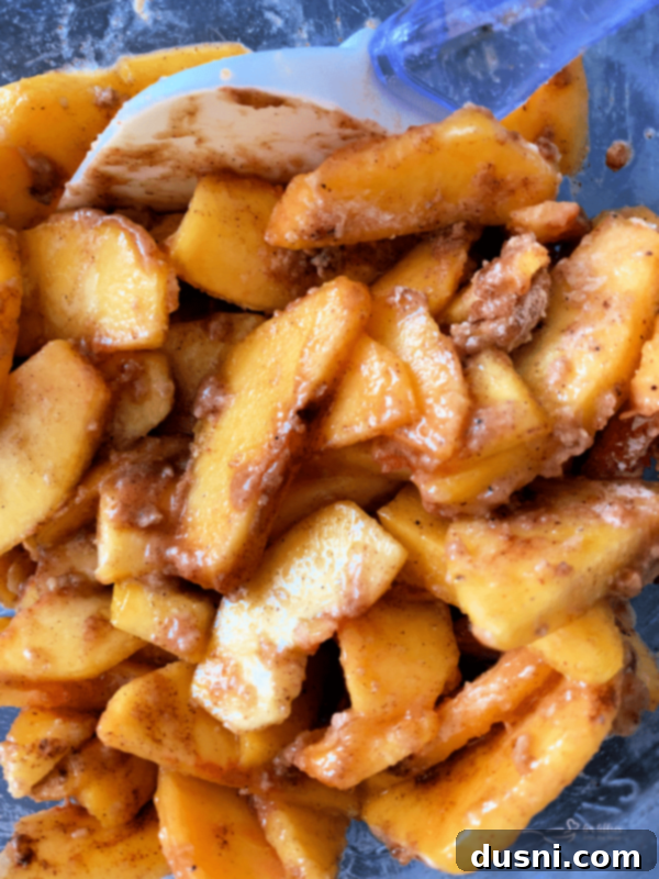 Golden Crumb Spiced Peach Pie 8 Close-up of peach filling in a mixing bowl.