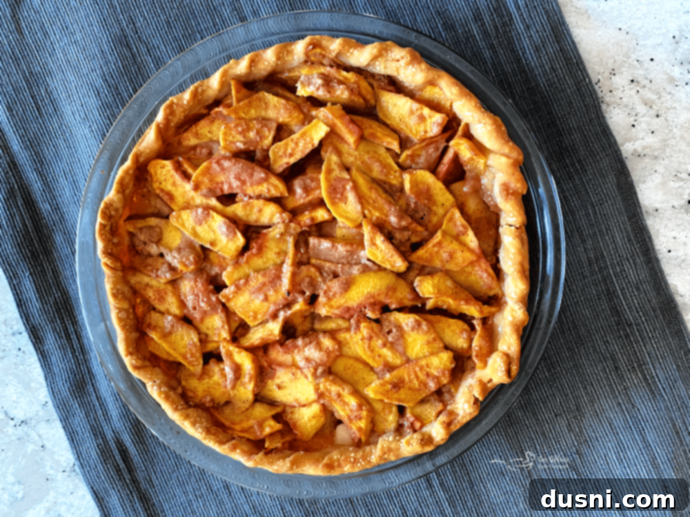 Golden Crumb Spiced Peach Pie 10 Peach pie baking in the oven.