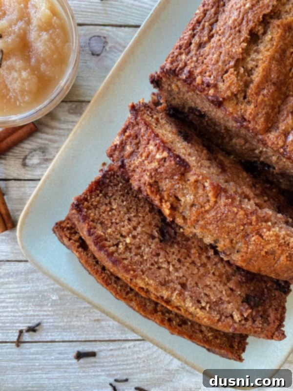 Chocolate Chip Applesauce Bread one loaf of applesauce bread on white plate with three slices