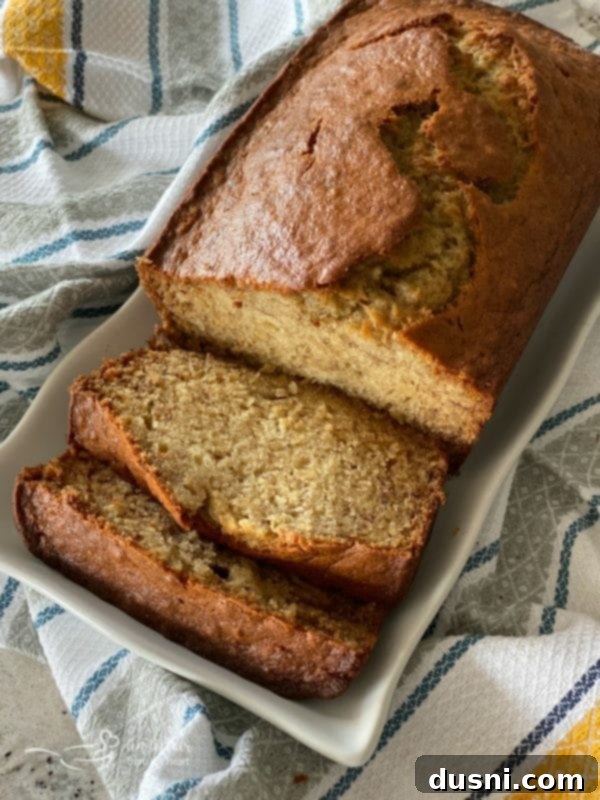 Spiced Applesauce & Dark Chocolate Loaf 3 overhead of The BEST Banana Bread on a white platter