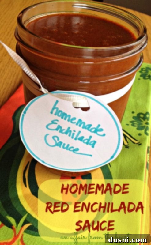 Homemade red enchilada sauce in a small dish with a spoon