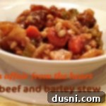 Slow-Simmered Beef and Barley Delight 2 Close up of Beef and Barley stew in a white bowl