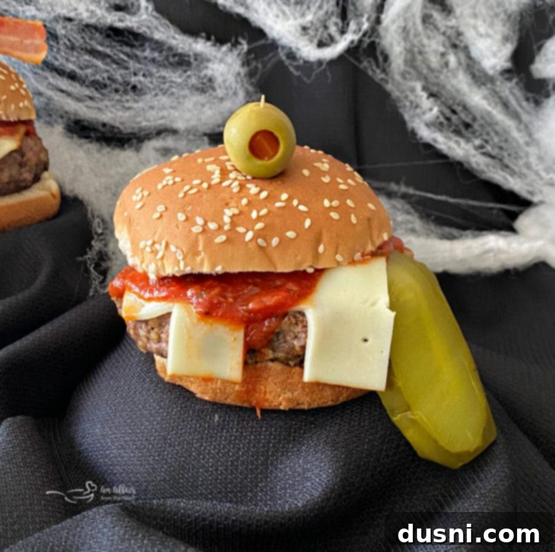 An array of uniquely decorated Halloween monster burgers, showcasing different creative approaches to cheese teeth, pickle tongues, and olive eyes.