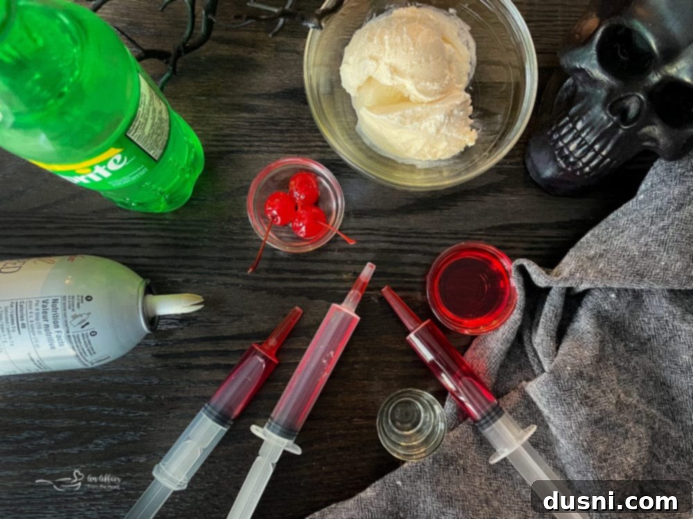 Ingredients laid out for a Bloody Dirty Shirley Float: grenadine, vodka, soda, ice cream, cherries, whipped cream