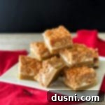 Salted Nut Roll Bars stacked on a white plate
