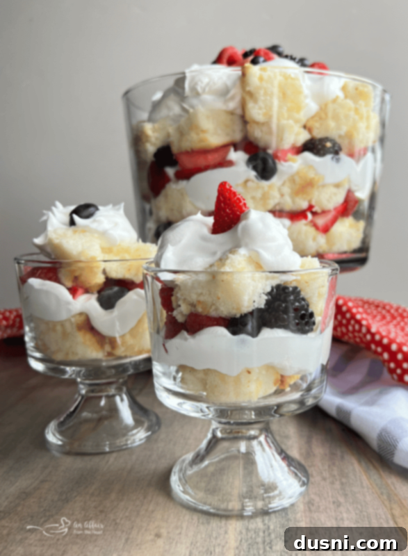 A close-up of the Berry Trifle showing distinct layers of cake, whipped cream, and berries, ready to be served.