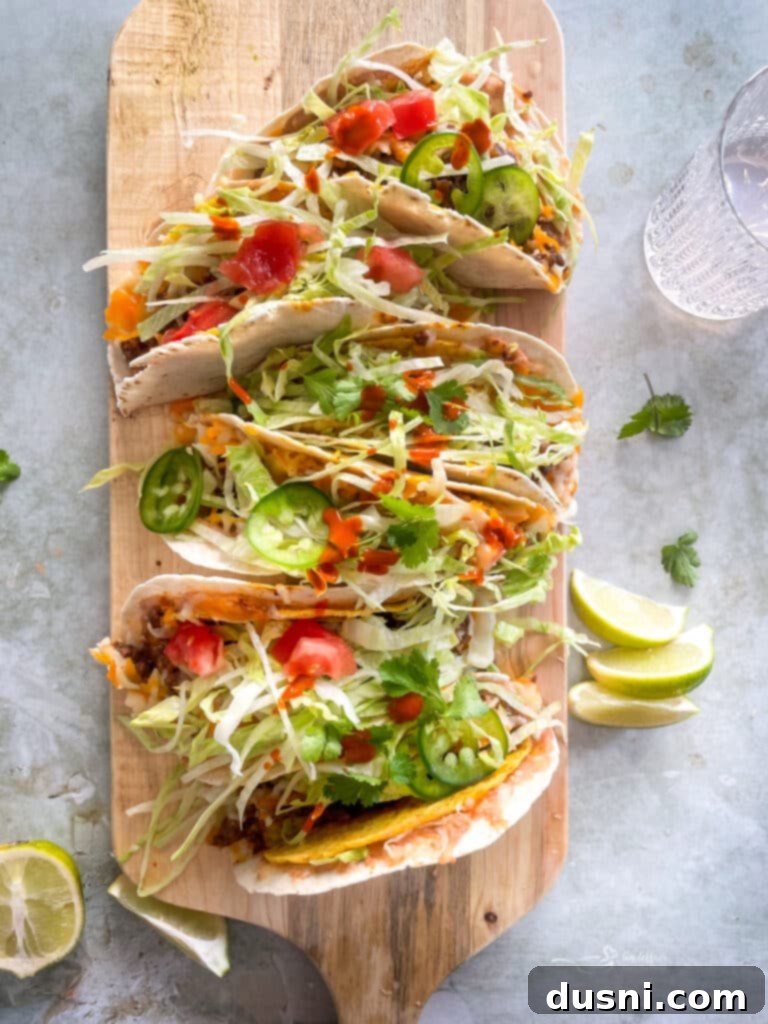 Close up of Double Decker Tacos layered on a wood board