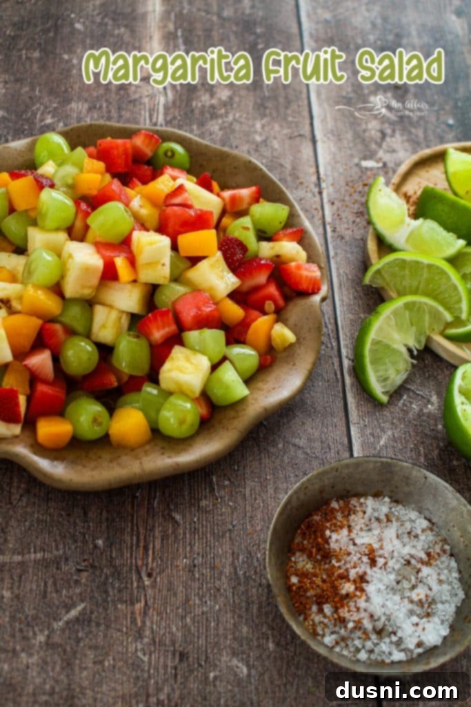 Large serving bowl of Margarita Fruit Salad on an outdoor table