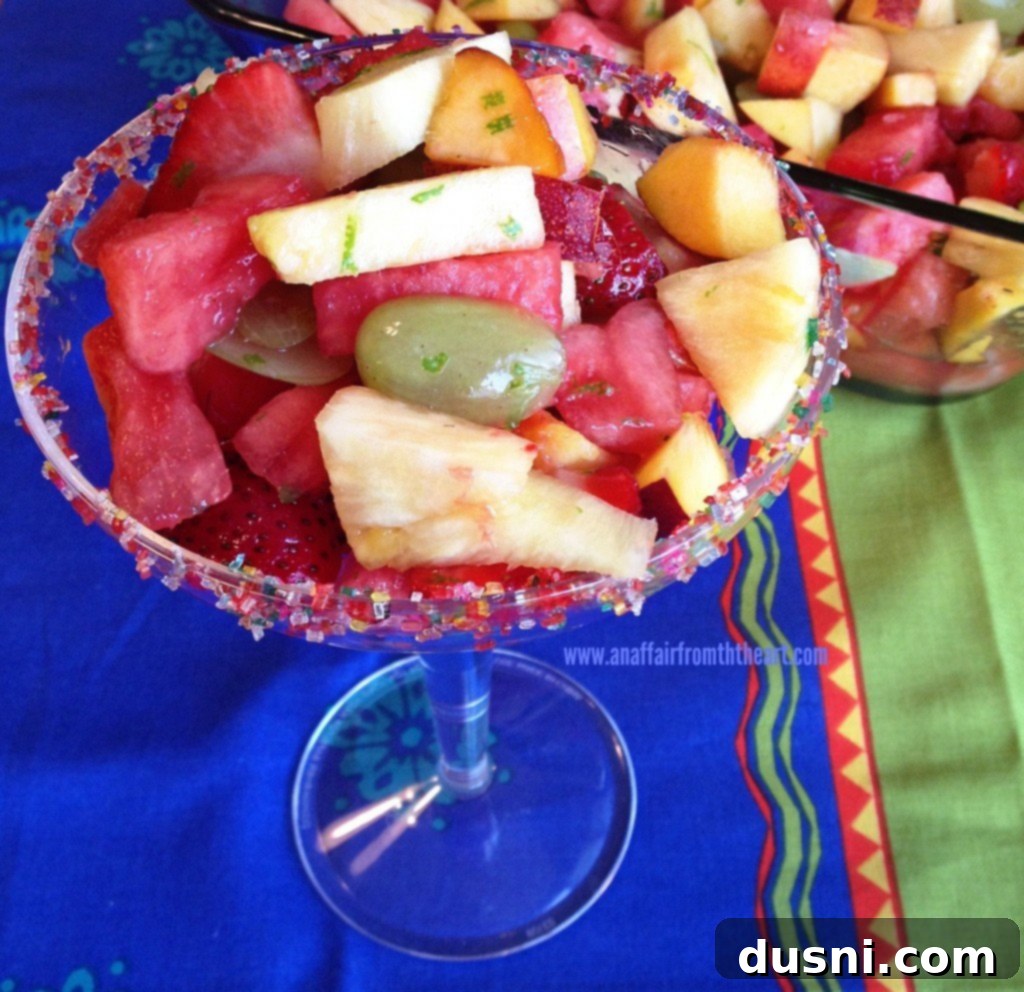 overhead shot of margarita fruit salad with a spoon