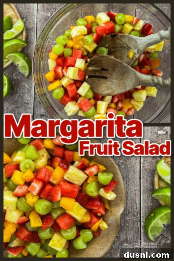 Margarita Fruit Salad in a large glass bowl with serving spoons