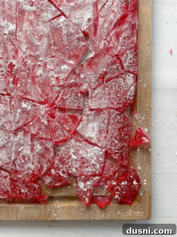 Christmas Cinnamon Rock Candy top view of cinnamon candy on cutting board with broken pieces and powdered sugar