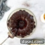 Velvet Espresso Chocolate Torte 19 Chocolate Espresso cake and a cake server on a white plate.