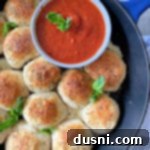 Italian Cheese Bombs in a cast iron skillet with marinara sauce