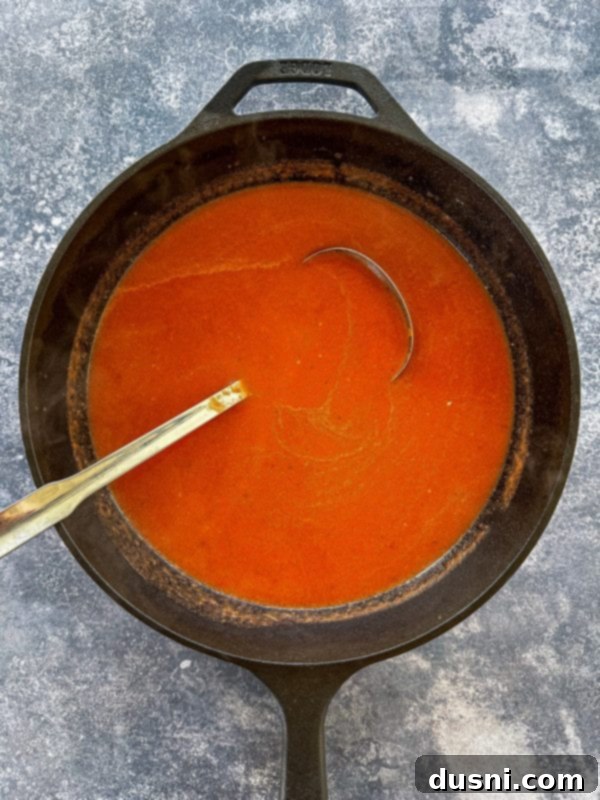 Soup being pureed in a blender after simmering.
