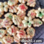 Close view of spritz cookies with sprinkles on a cooling rack