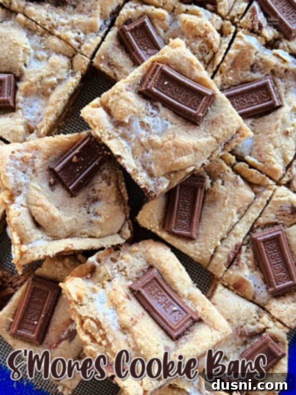 Gooey S'mores Cookie Bars 15 A stack of S'mores Cookie Bars with a bite taken out of one