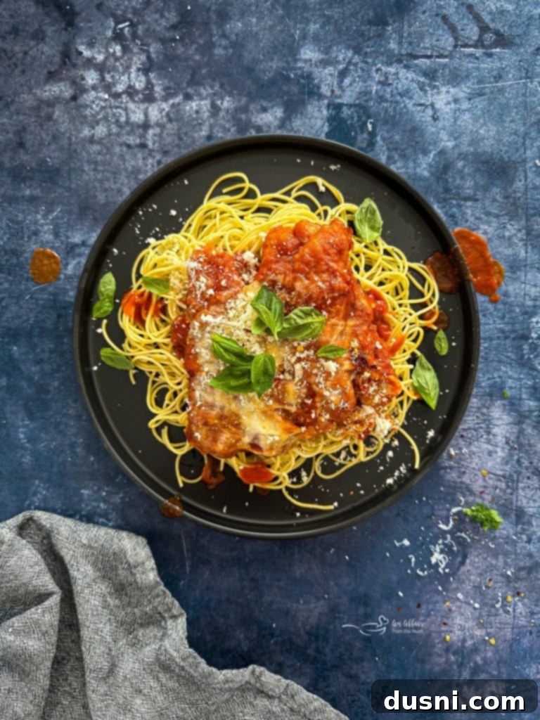 Busy Nights Chicken Parmesan Bake 2 Easy Weeknight Chicken Parmesan with pasta on a plate.