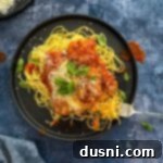 Busy Nights Chicken Parmesan Bake 15 Easy Weeknight Chicken Parmesan on a dark colored plate.