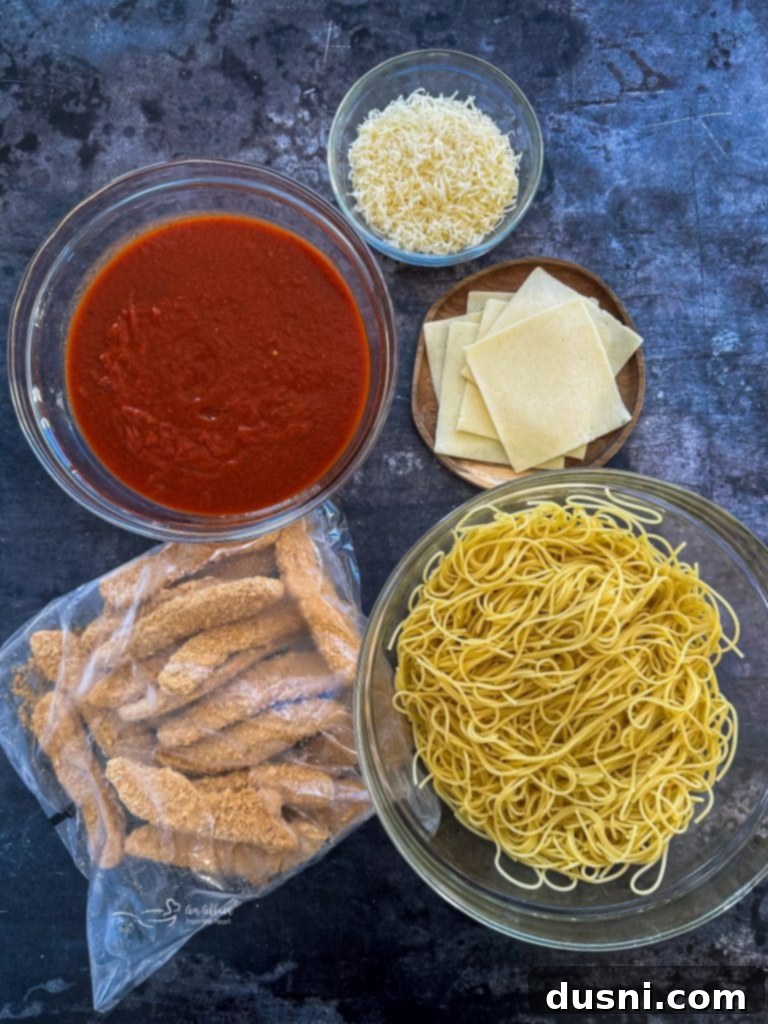 Busy Nights Chicken Parmesan Bake 5 Cooked chicken parmesan on a plate with pasta, ready to serve.