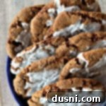 Timeless Iced Molasses Treats 3 A vibrant image of iced molasses ginger cookies, soft and chewy, nestled in a charming blue container, inviting you to taste.