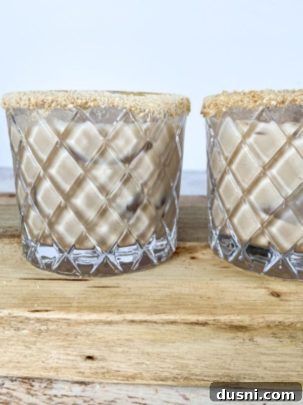 Velvet Pumpkin White Russian 12 Several sugar-rimmed glasses filled with Pumpkin White Russian cocktails, artfully arranged for a holiday gathering.