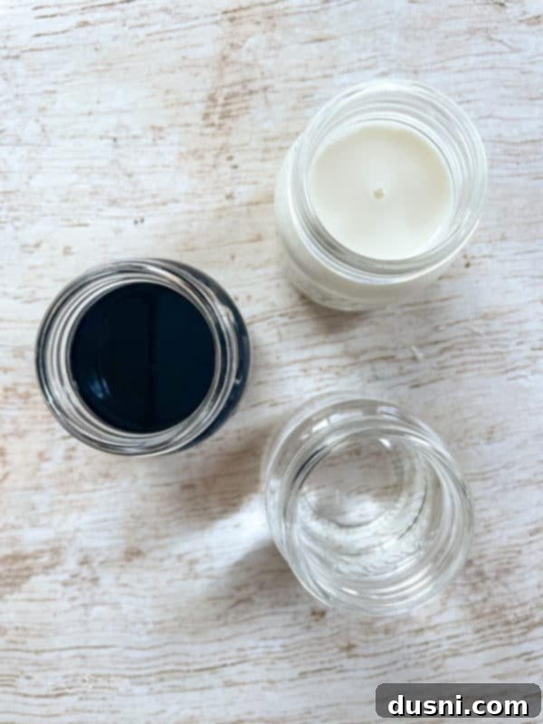 Velvet Pumpkin White Russian 3 Bottles of Kahlua, pumpkin spice creamer, and vodka lined up as ingredients for a Pumpkin White Russian cocktail.