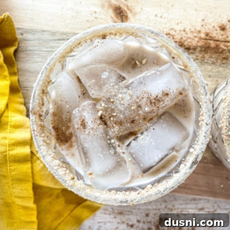 Velvet Pumpkin White Russian 9 Two Pumpkin White Russian cocktails in sugar and spice-rimmed glasses, ready for a festive celebration.