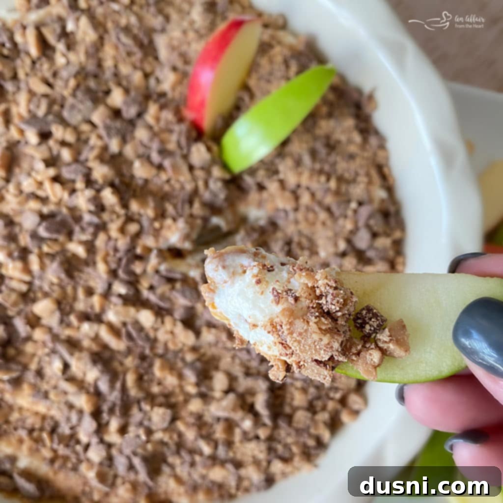 Close-up of caramel apple dip with apple slices ready for dipping.