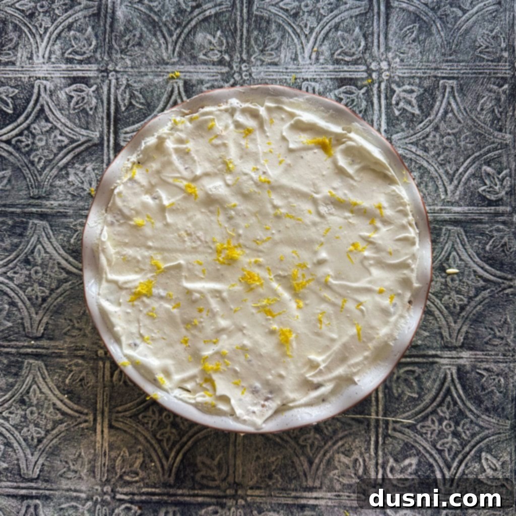 Effortless Lemon Dream Pie 11 Lemon Icebox Pie in a glass pie plate, freshly made, with a smooth yellow top.