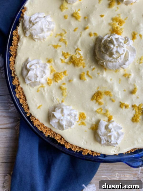 Effortless Lemon Dream Pie 8 A bowl of melted butter and graham cracker crumbs, ready to be mixed for the pie crust.