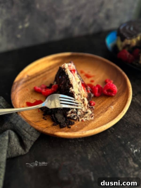 Luxurious White Chocolate Raspberry Truffle Cheesecake 2 Decadent White Chocolate Raspberry Cheesecake with dark chocolate drizzle and fresh raspberries