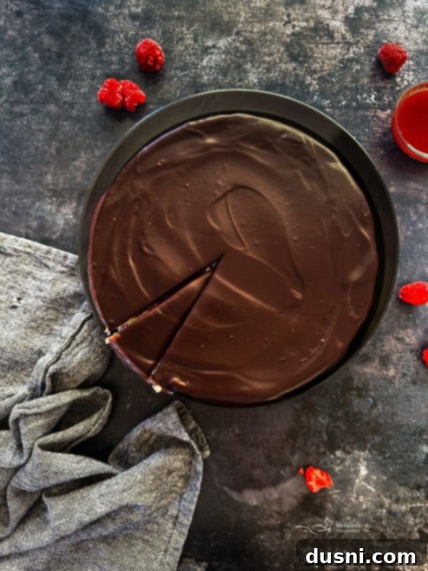 Luxurious White Chocolate Raspberry Truffle Cheesecake 21 Full White Chocolate Raspberry Cheesecake on a pedestal