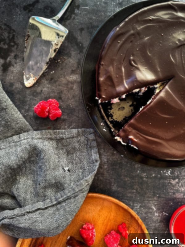 Luxurious White Chocolate Raspberry Truffle Cheesecake 22 Side view of white chocolate raspberry cheesecake