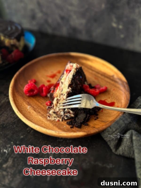Luxurious White Chocolate Raspberry Truffle Cheesecake 25 Full White Chocolate Raspberry Cheesecake with a slice out, showing layers