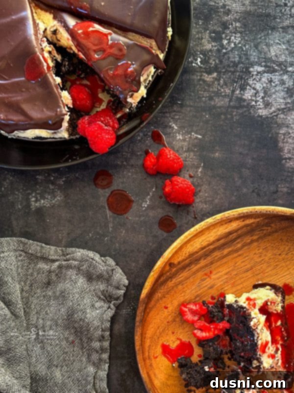 Luxurious White Chocolate Raspberry Truffle Cheesecake 4 Close-up of a slice of White Chocolate Raspberry Cheesecake with a perfect swirl