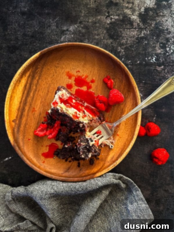 Luxurious White Chocolate Raspberry Truffle Cheesecake 5 Beautifully presented white chocolate raspberry cheesecake on a wooden board