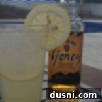 bourbon lemonade in a tall glass with a lemon slice garnish