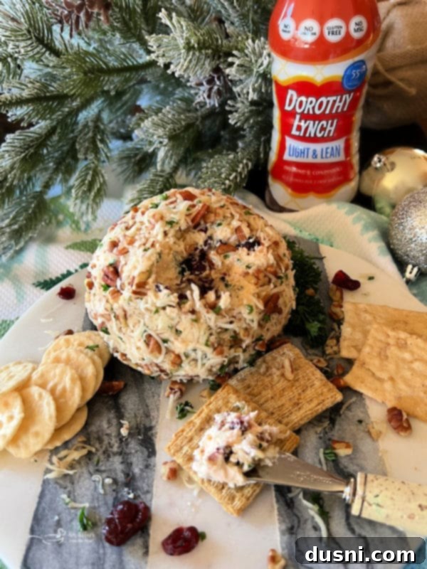 A festive holiday spread featuring Dorothy's Holiday Cheese Ball and other appetizers, all beautifully arranged.