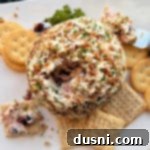 Close up of the interior texture of Dorothy's Holiday Cheese Ball, showing cranberries and cheese.